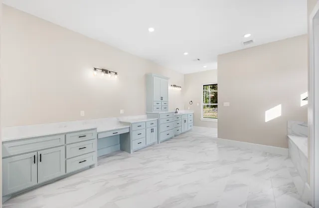 a bathroom with a granite countertop sink mirror and a toilet