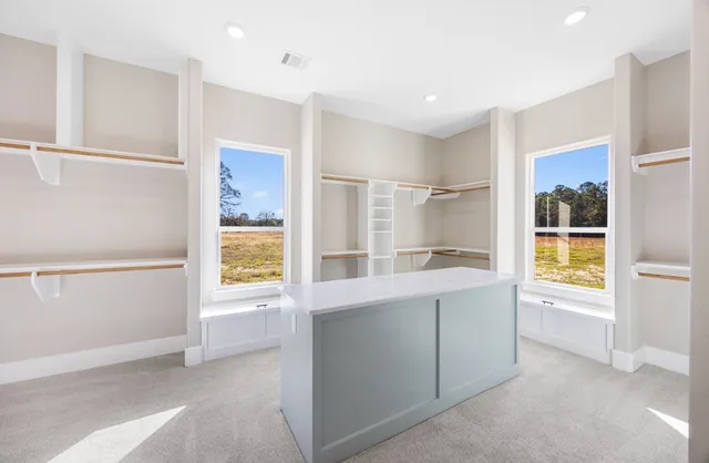 a large white kitchen with a large window