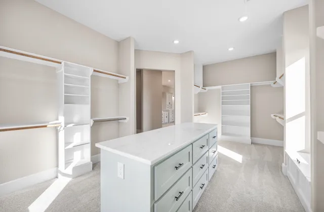a kitchen with white cabinets and refrigerator