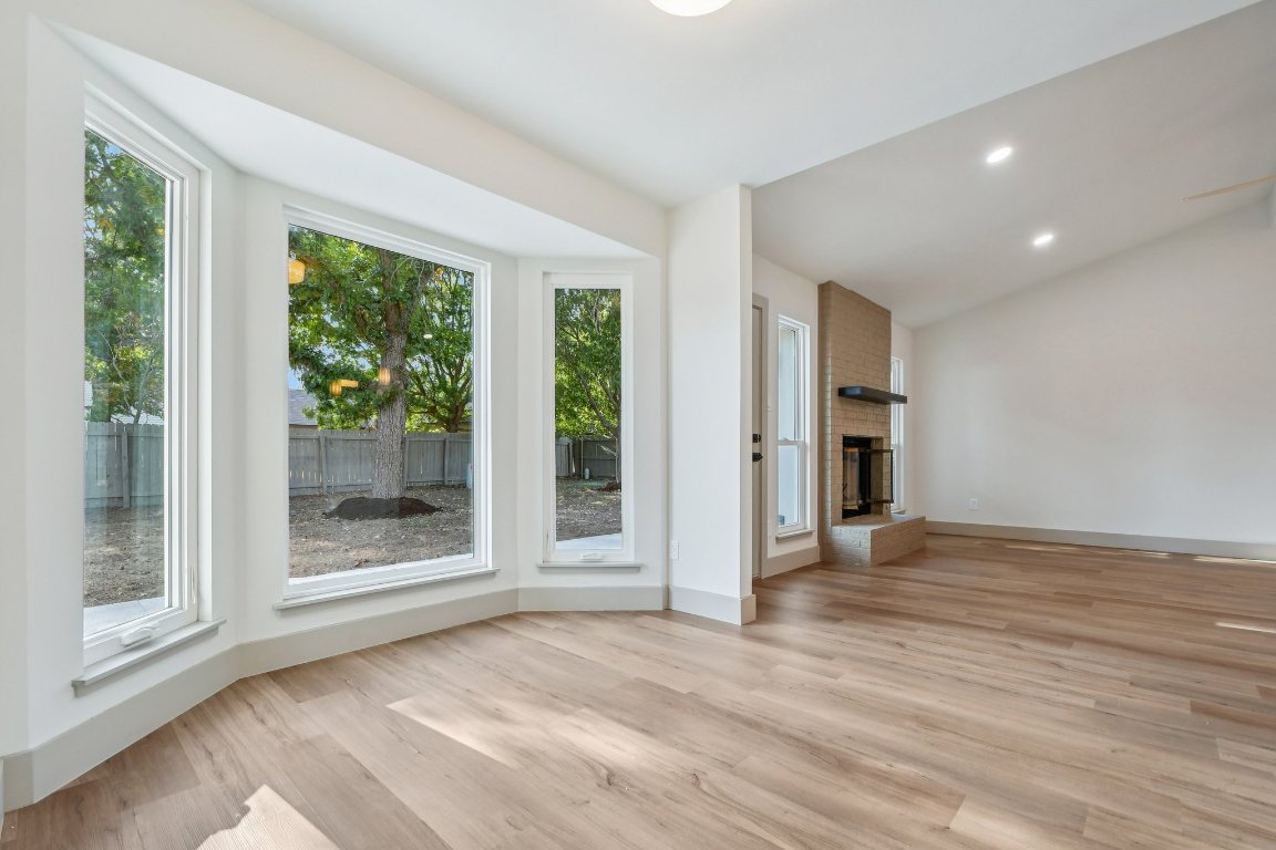 417 Oakridge Pass Cedar Park, TX 78613 - Photo 14 of 33 a view of an empty room with a window and wooden floor