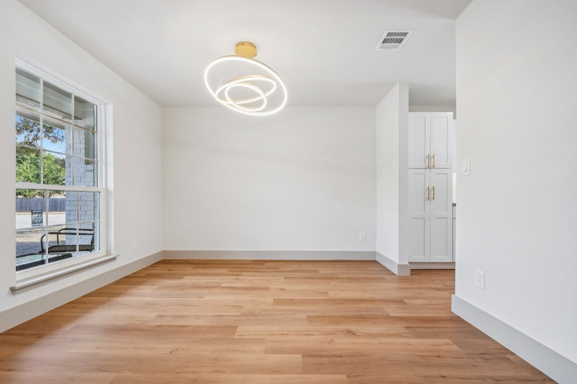 417 Oakridge Pass Cedar Park, TX 78613 - Photo 16 of 33 a view of an empty room with wooden floor and a window