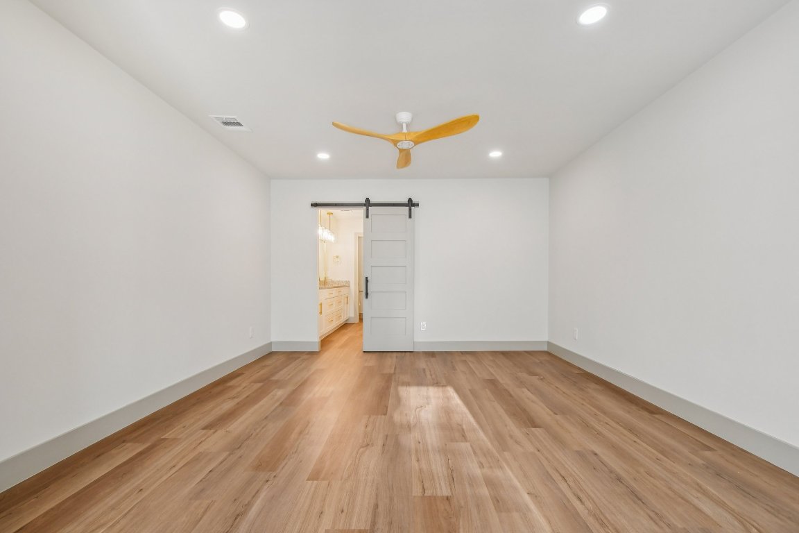 417 Oakridge Pass Cedar Park, TX 78613 - Photo 18 of 33 an empty room with wooden floor and a ceiling fan