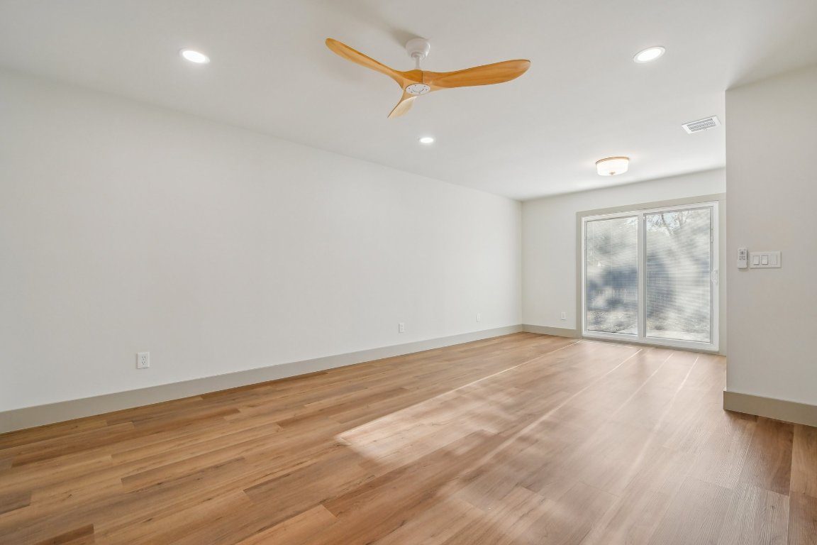 417 Oakridge Pass Cedar Park, TX 78613 - Photo 20 of 33 an empty room with wooden floor and windows