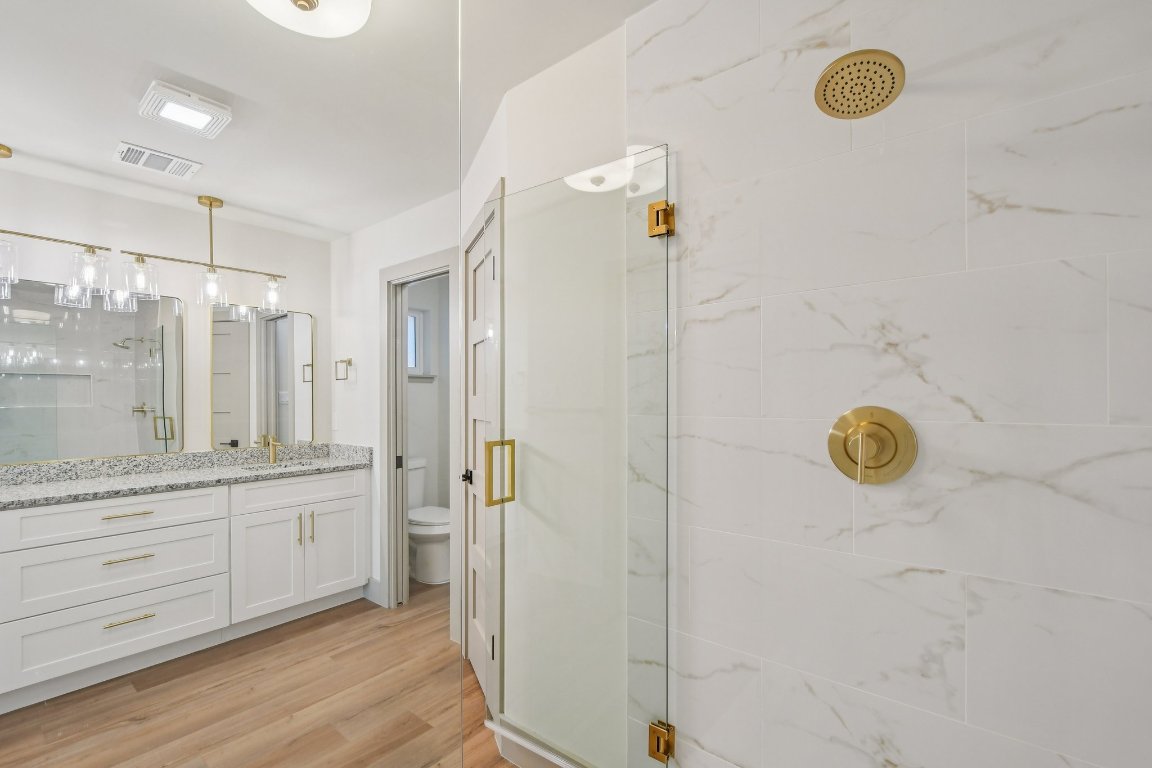 417 Oakridge Pass Cedar Park, TX 78613 - Photo 23 of 33 a bathroom with a granite countertop shower sink and mirror