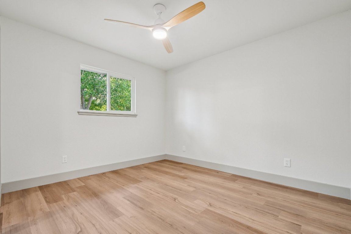 417 Oakridge Pass Cedar Park, TX 78613 - Photo 25 of 33 an empty room with wooden floor and windows