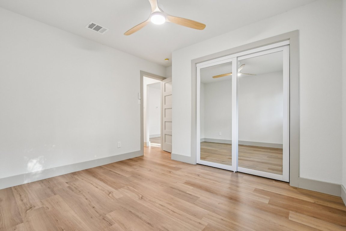 417 Oakridge Pass Cedar Park, TX 78613 - Photo 26 of 33 an empty room with wooden floor closet and windows