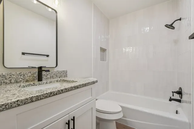 a front view of a house with a garden and trees