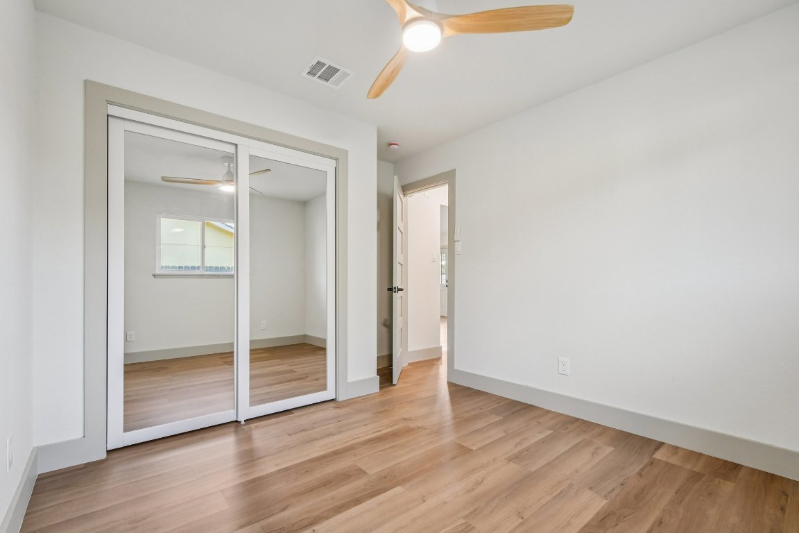 417 Oakridge Pass Cedar Park, TX 78613 - Photo 28 of 33 an empty room with wooden floor and windows