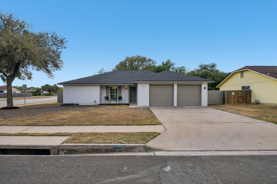 417 Oakridge Pass Cedar Park, TX 78613 - Photo 4 of 33 a front view of a house with a yard and garage