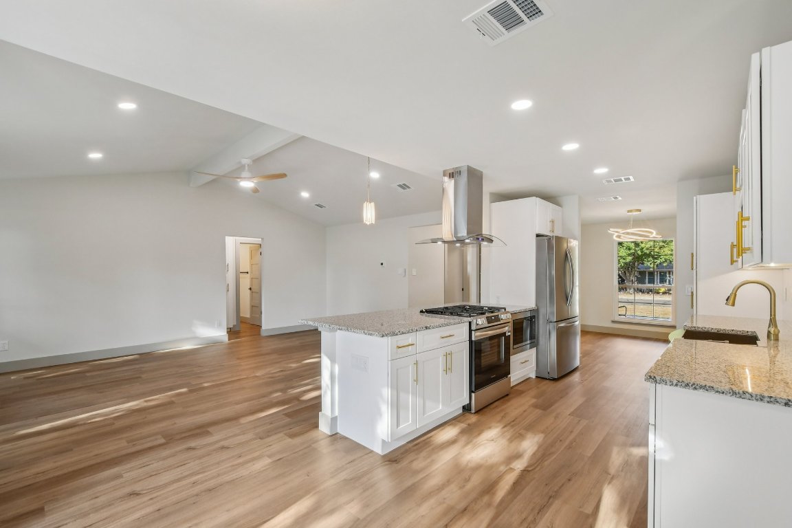 417 Oakridge Pass Cedar Park, TX 78613 - Photo 8 of 33 a large kitchen with stainless steel appliances kitchen island granite countertop a large counter top and stove