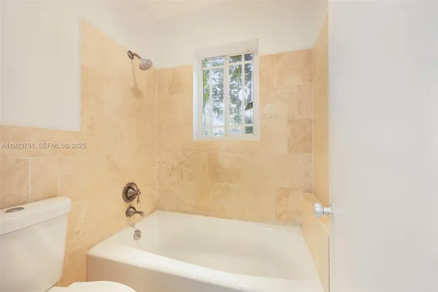 a white bath tub sitting next to a white toilet