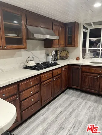 a spacious bathroom with a granite countertop sink and a mirror