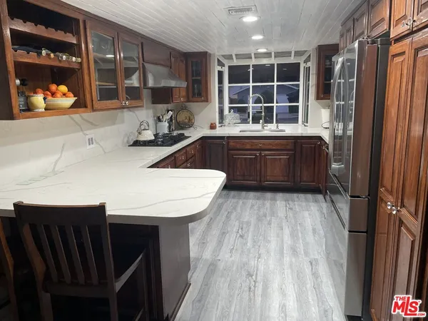 a kitchen with a sink and wooden cabinets