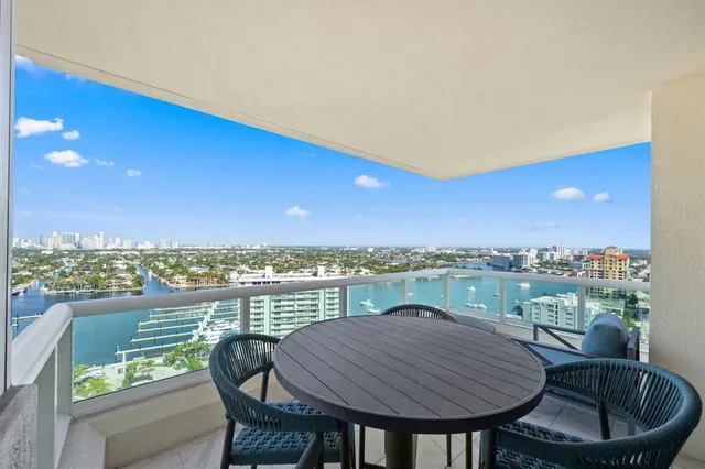 a view of a balcony with table and chairs