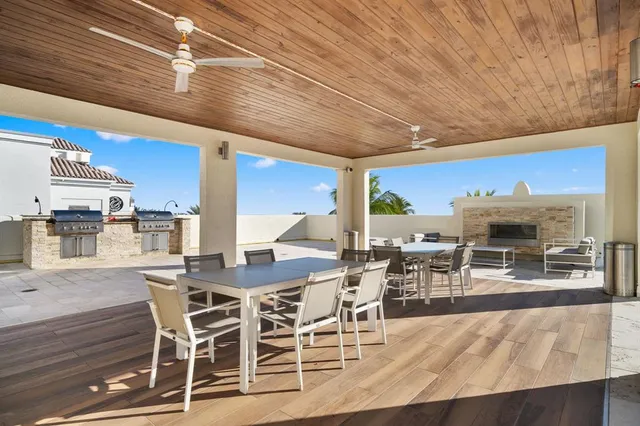 a dining hall with stainless steel appliances a dining table and chairs with wooden floor