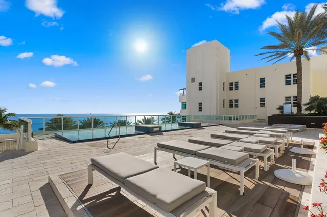 a view of a patio with a table and chairs