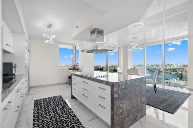 a kitchen with stainless steel appliances kitchen island granite countertop a stove a sink and a microwave