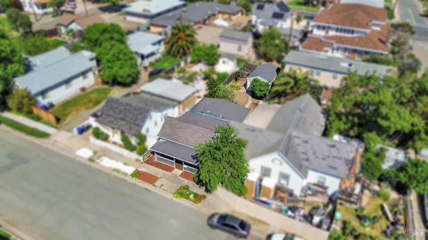 an aerial view of multiple houses with yard