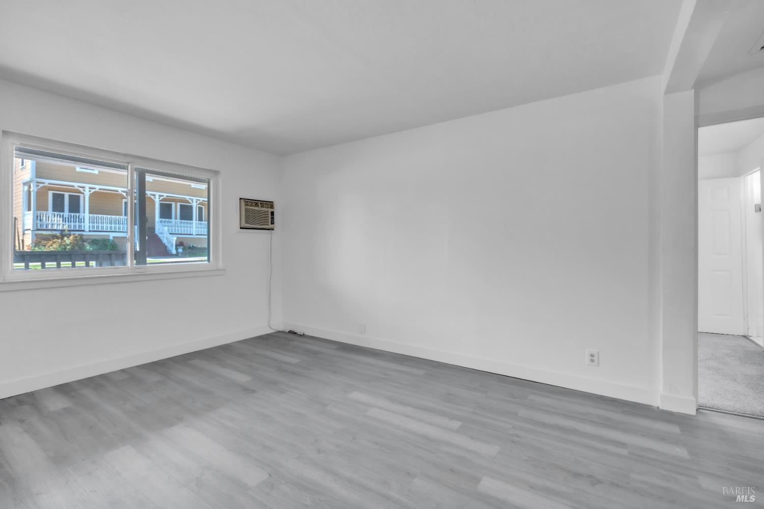 514 Montezuma Street Rio Vista, CA 94571 - Photo 8 of 36 a view of an empty room with wooden floor and a window
