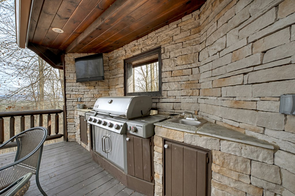 260 Observation Lane Blue Ridge, GA 30513 - Photo 16 of 100 a kitchen with stainless steel appliances granite countertop a stove a sink dishwasher and cabinets
