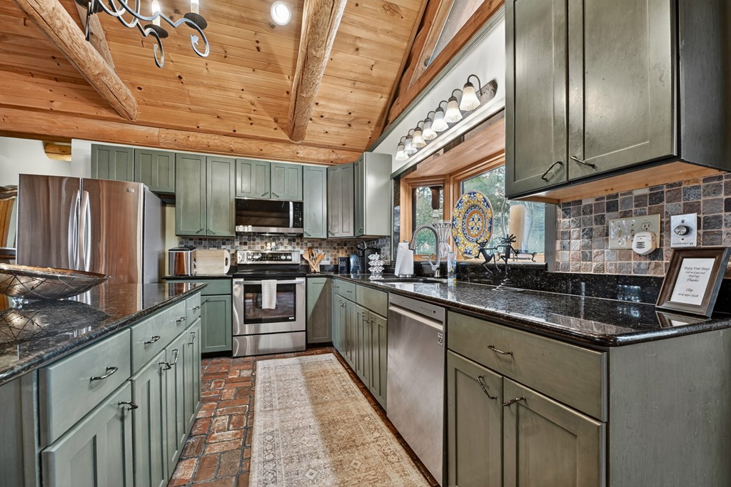 260 Observation Lane Blue Ridge, GA 30513 - Photo 33 of 100 a kitchen with stainless steel appliances granite countertop a sink a stove and a refrigerator