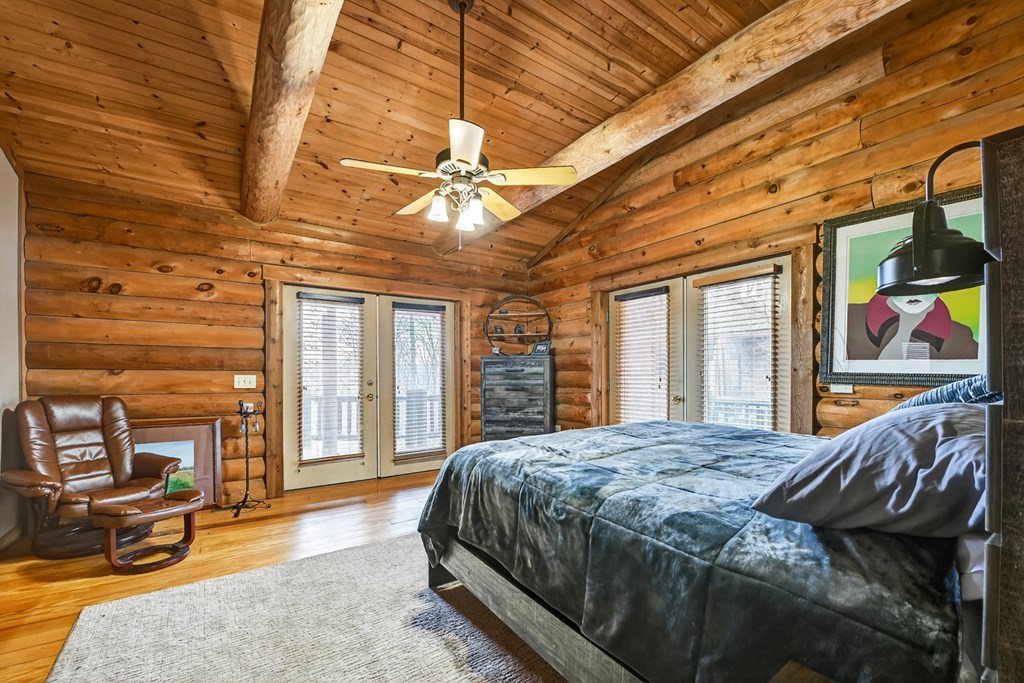 260 Observation Lane Blue Ridge, GA 30513 - Photo 35 of 100 a bed sitting in a spacious bedroom next to a window
