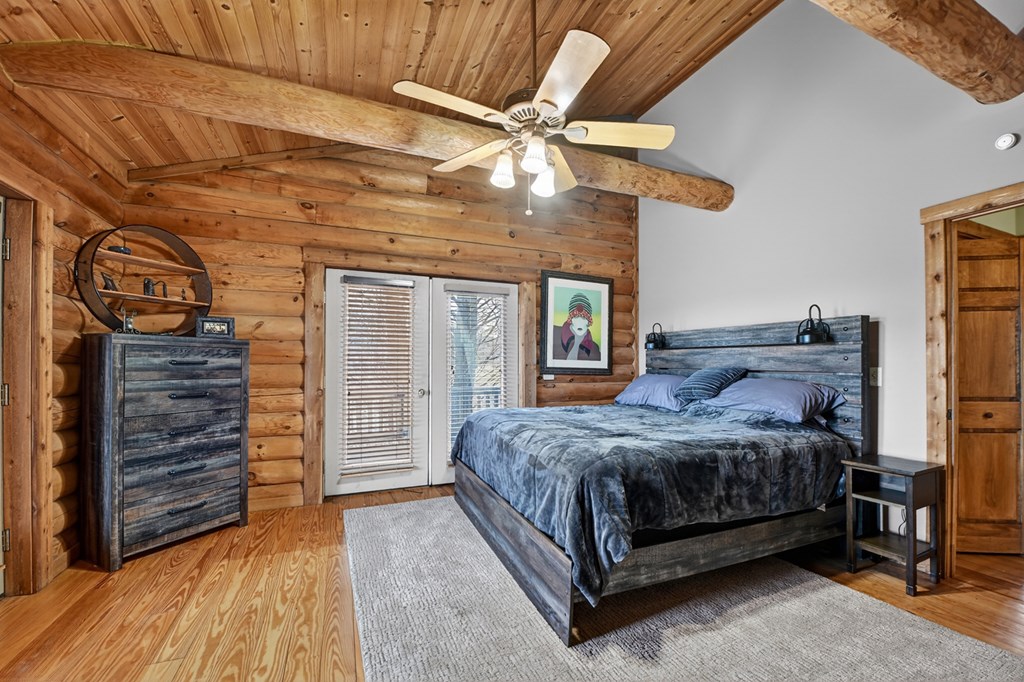 260 Observation Lane Blue Ridge, GA 30513 - Photo 36 of 100 a bedroom with a bed and a ceiling fan