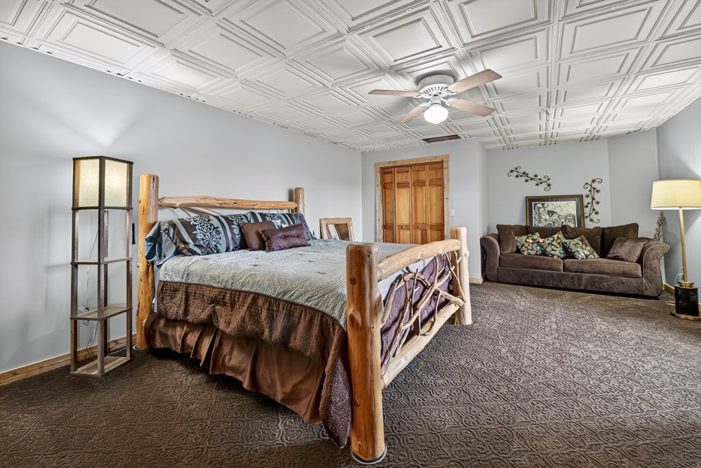 260 Observation Lane Blue Ridge, GA 30513 - Photo 54 of 100 a bedroom with a bed and ceiling fan