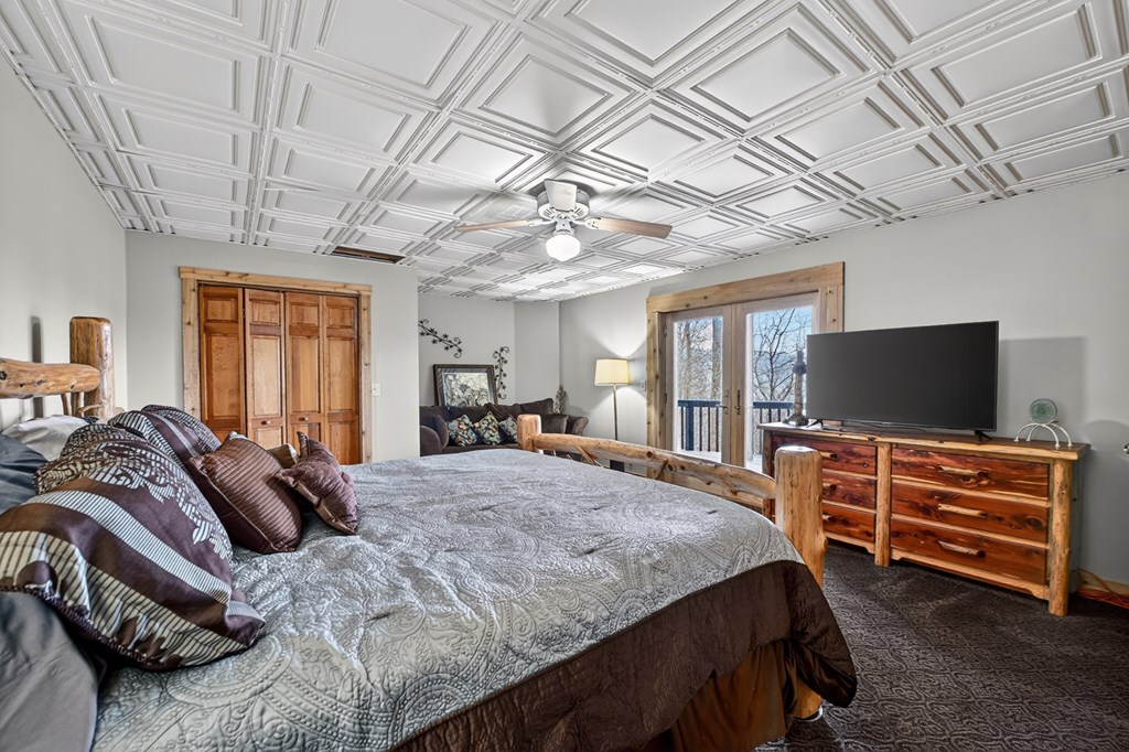 260 Observation Lane Blue Ridge, GA 30513 - Photo 55 of 100 a bedroom with a bed and flat screen tv