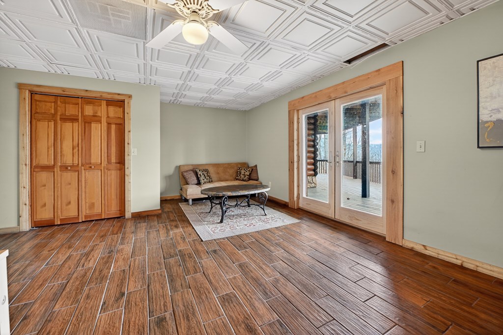 260 Observation Lane Blue Ridge, GA 30513 - Photo 57 of 100 a living room with furniture a wooden floor and next to a window