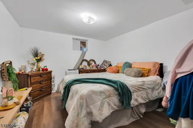 a bed sitting in a bedroom next to a lamp