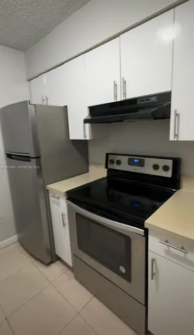a kitchen with a sink and a stove