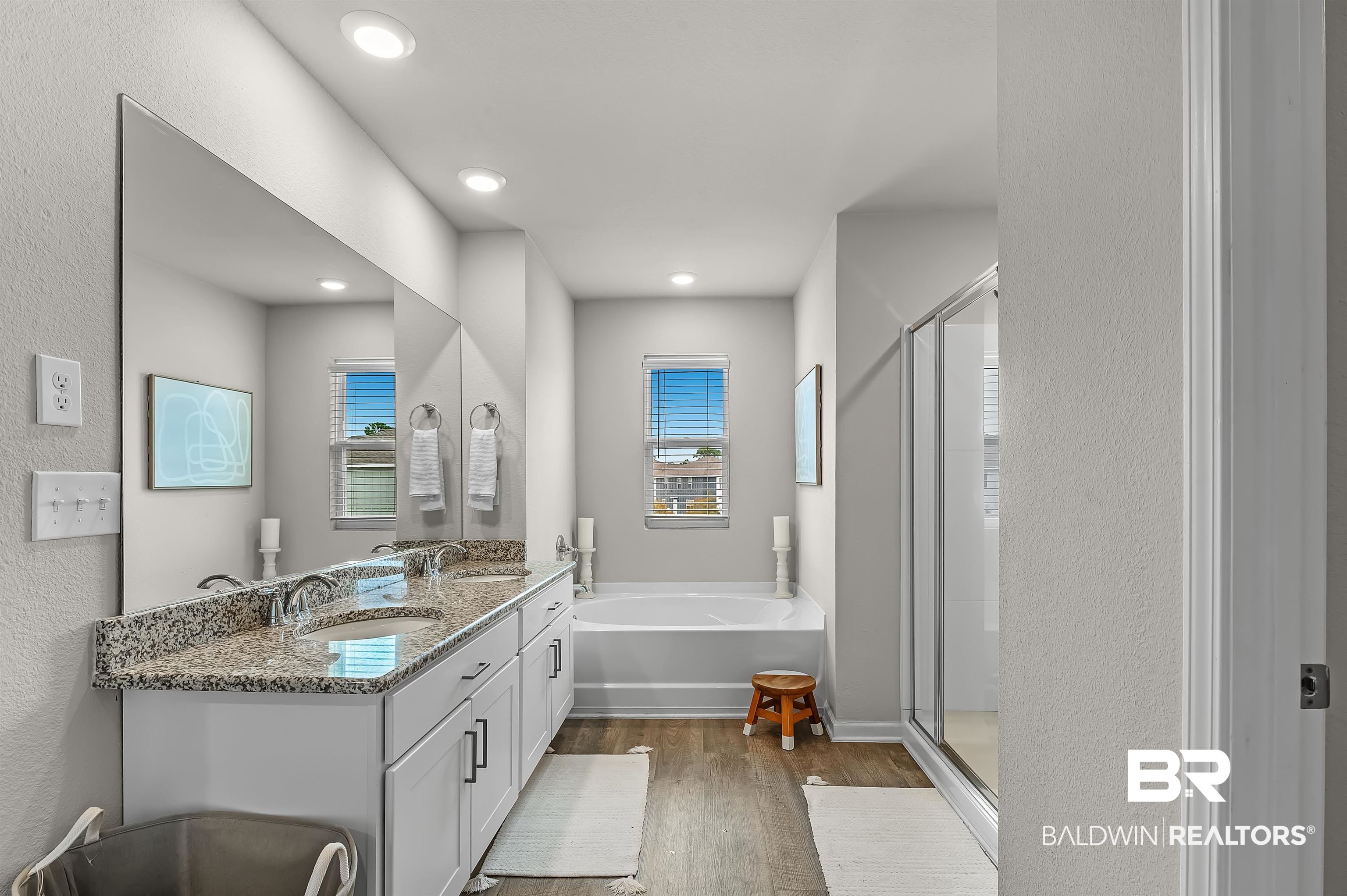 24549 Broken Sound Loop Orange Beach, AL 36561 - Photo 31 of 57 Bathroom featuring a healthy amount of sunlight, hardwood / wood-style floors, vanity, and independent shower and bath