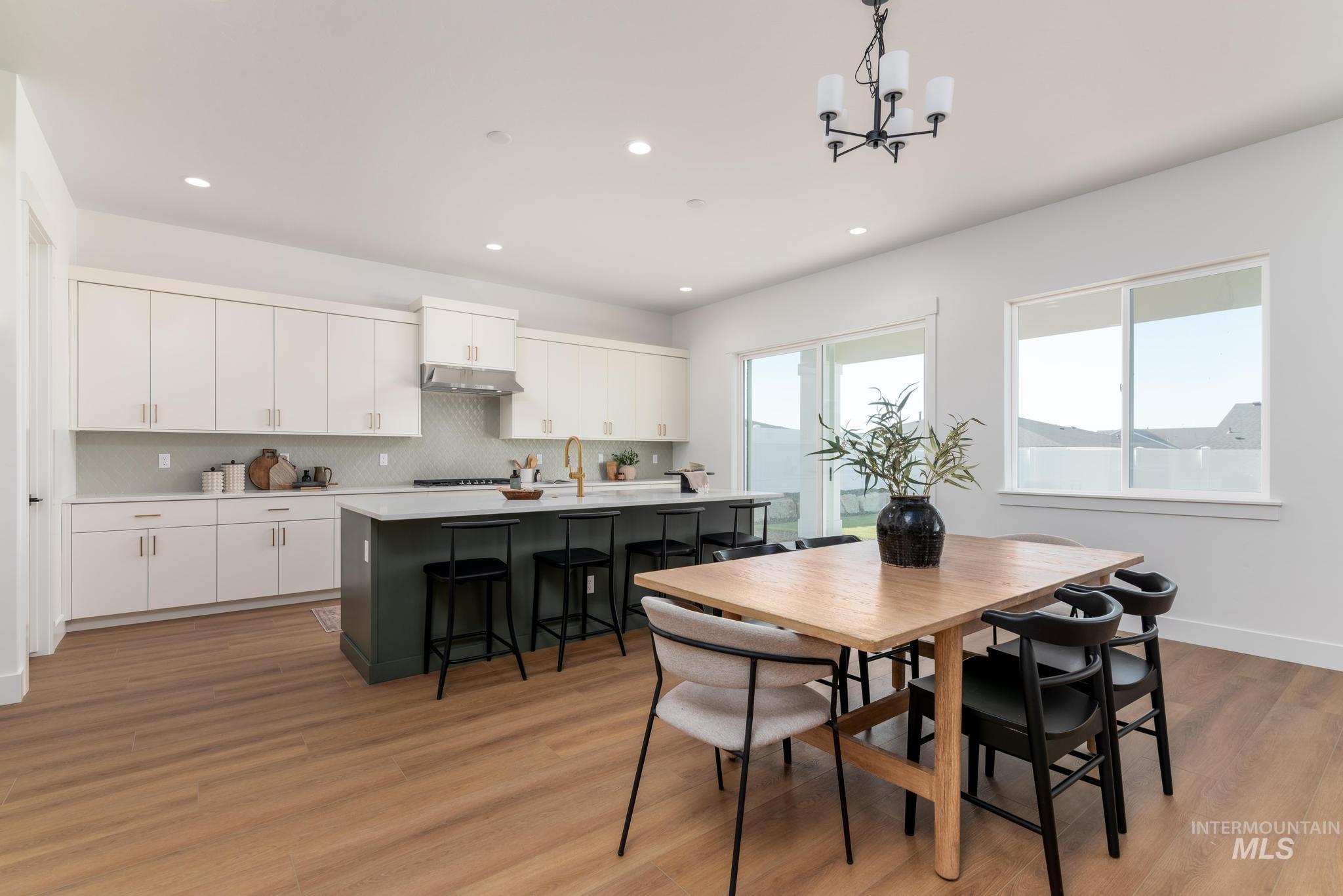 14703 Serenity Pt Street Caldwell, ID 83607 - Photo 10 of 45 Open-concept kitchen and dining area featuring light wood-finish flooring