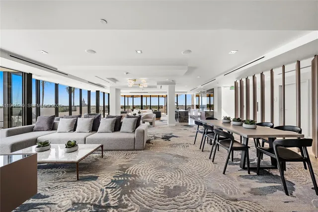 a view of a patio with table and chairs with wooden floor and fence