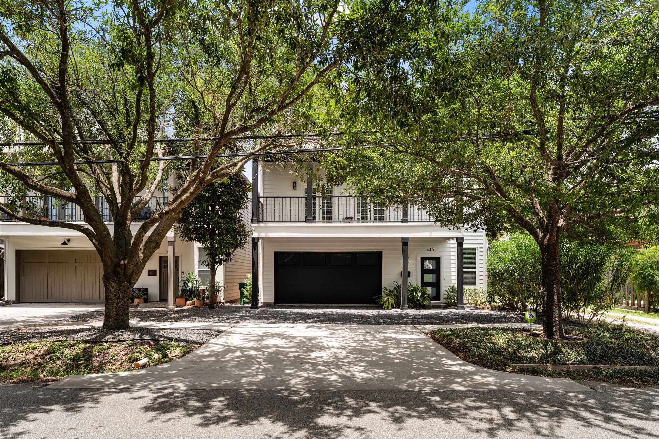 415 West 8th Street Houston, TX 77007 - Photo 2 of 39 Nestled beneath a canopy of mature trees, this striking home offers timeless curb appeal with crisp white siding, bold black accents, an oversized covered balcony, and a two-car garage. A perfect blend of modern style and classic Heights charm.