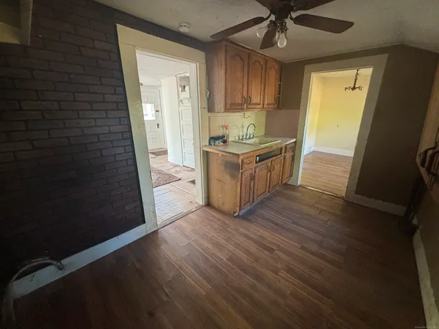 a kitchen with granite countertop a sink and a refrigerator