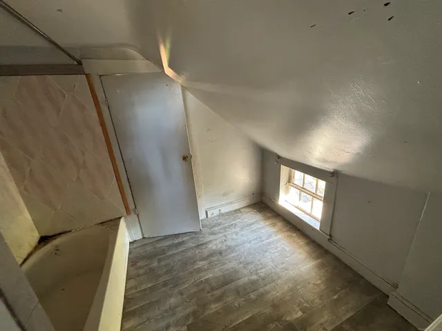 a view of an empty room and wooden floor