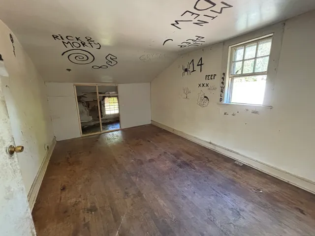 wooden floor in a hall with a window