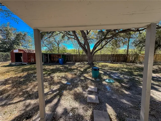 a view of a backyard with large tree