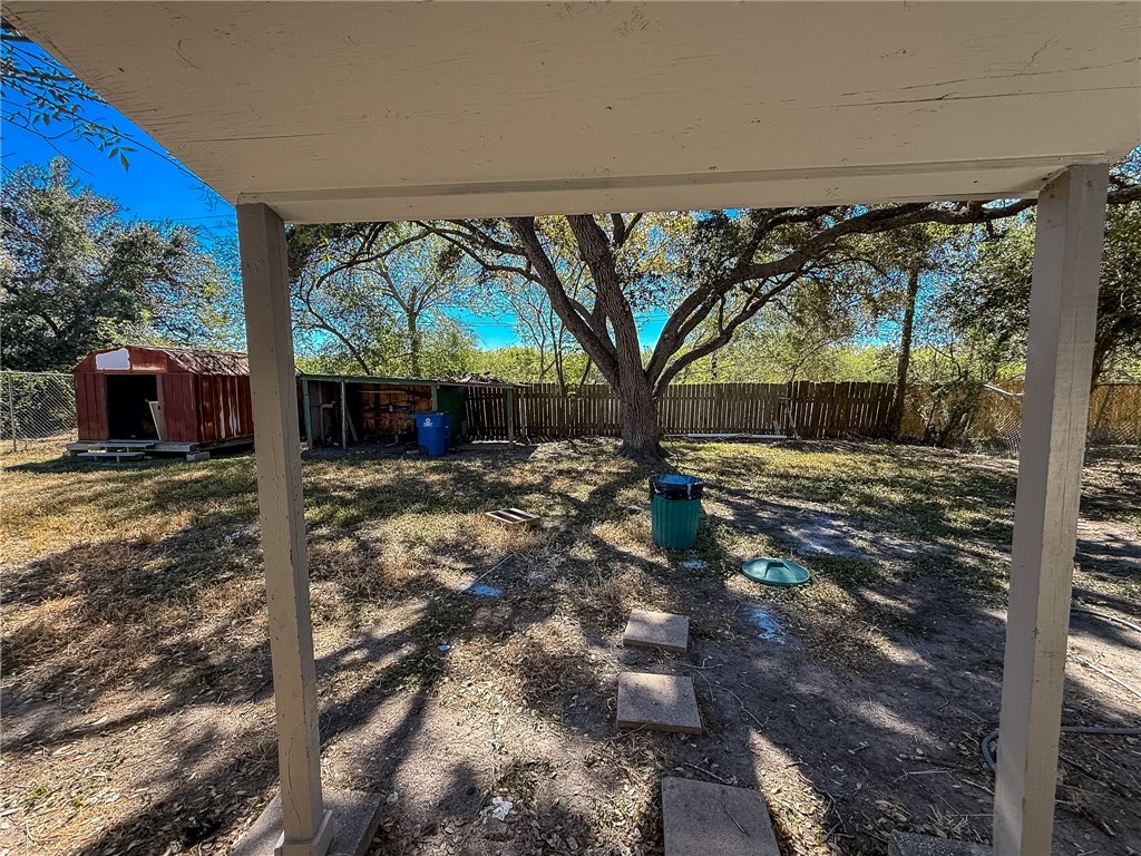 833 Booty Street Sinton, TX 78387 - Photo 8 of 9 a view of a backyard with large tree
