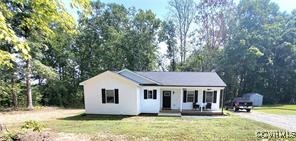 215 Johnson Mill Road Bumpass, VA 23024 - Photo 2 of 9 a front view of a house with a yard and trees