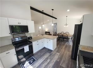 215 Johnson Mill Road Bumpass, VA 23024 - Photo 4 of 9 a large kitchen with a table chairs refrigerator and a stove