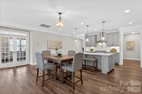 a view of a dining room with furniture wooden floor and chandelier
