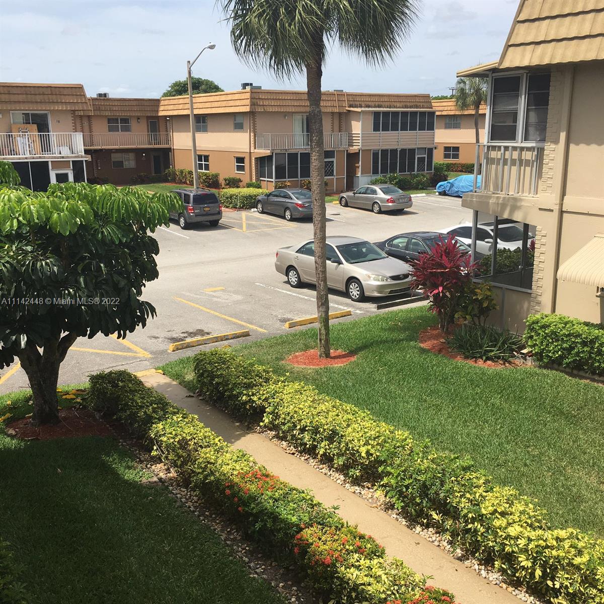 218 Brittany F, Unit E Delray Beach, FL 33446 - Photo 13 of 21 a view of a house with backyard porch and sitting area
