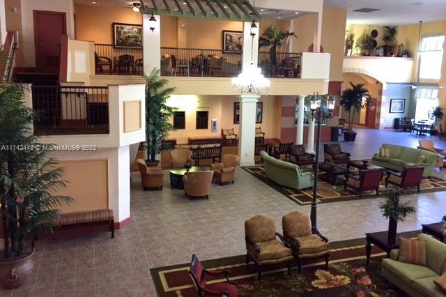 218 Brittany F, Unit E Delray Beach, FL 33446 - Photo 16 of 21 a view of a patio with dining table and chairs