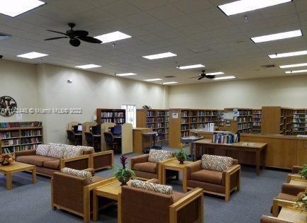 218 Brittany F, Unit E Delray Beach, FL 33446 - Photo 17 of 21 a living room with lots of furniture and clutter