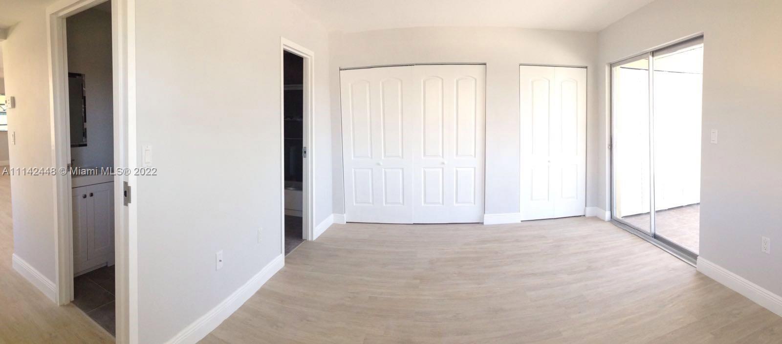 218 Brittany F, Unit E Delray Beach, FL 33446 - Photo 8 of 21 a view of an empty room with a window