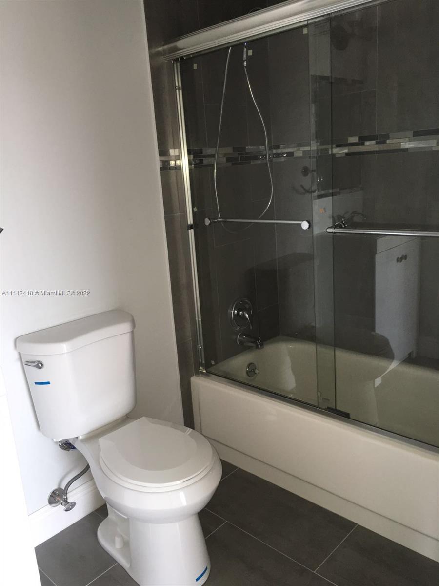 218 Brittany F, Unit E Delray Beach, FL 33446 - Photo 9 of 21 a bathroom with a toilet and a tub