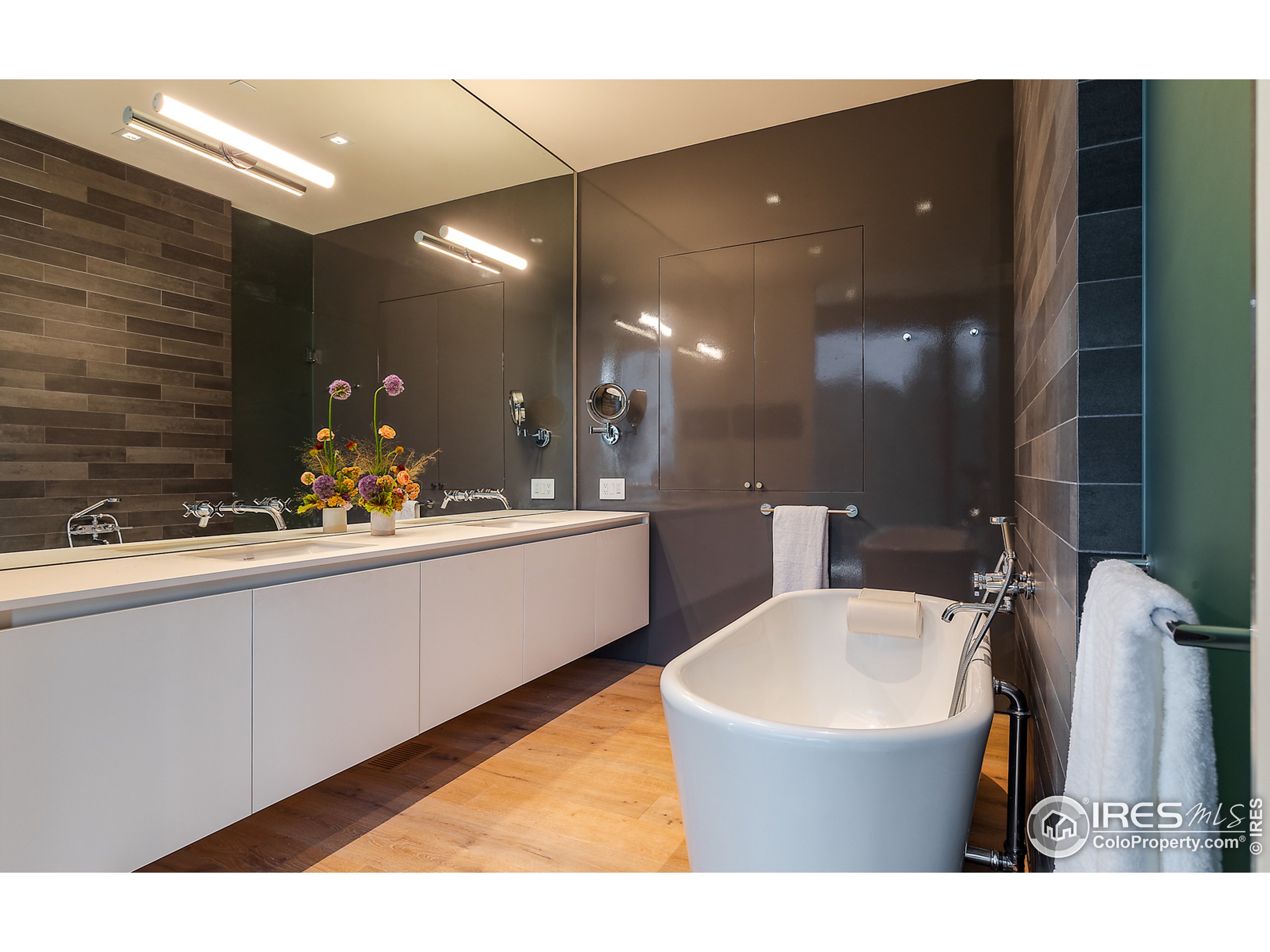 Undisclosed Address Boulder, CO 80302 - Photo 25 of 40 a bathroom with a sink a mirror and a bathtub